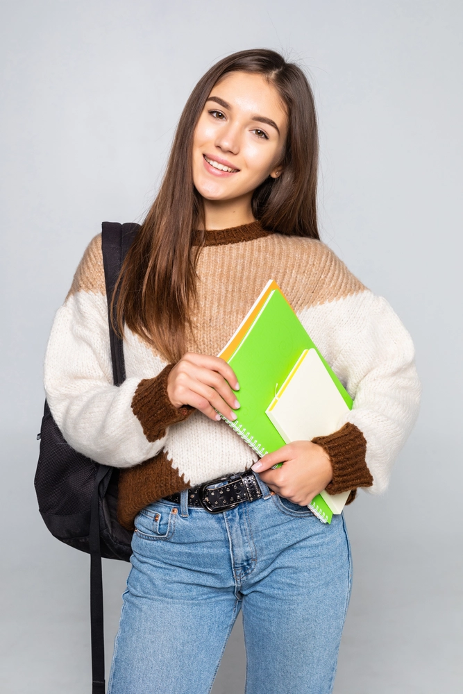 student holding books - Foreign university admission guidance for students